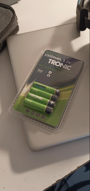Pack of four 1000mAh AAA 1.2V TRONIC rechargeable batteries on a desk