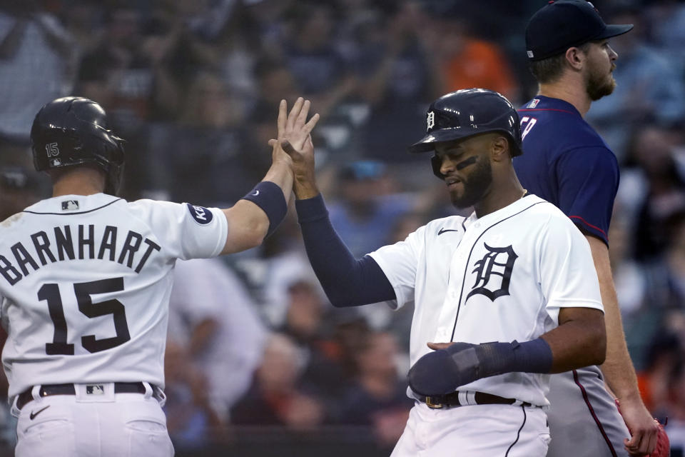Detroit Tigers' Tucker Barnhart (15) greets Willi Castro after they both scored on a double by teammate Harold Castro during the fifth inning of a baseball game against the Minnesota Twins, Wednesday, June 1, 2022, in Detroit. (AP Photo/Carlos Osorio)