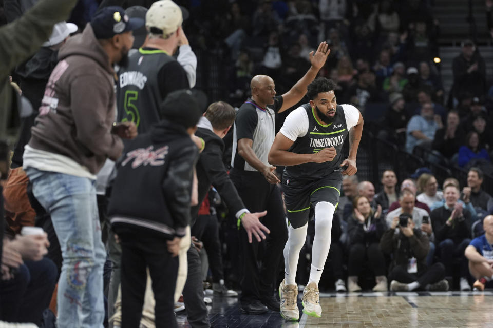 Minnesota Timberwolves center Karl-Anthony Towns jogs down the court after making a three-point shot during the first half of an NBA basketball game against the Charlotte Hornets, Monday, Jan. 22, 2024, in Minneapolis. (AP Photo/Abbie Parr)