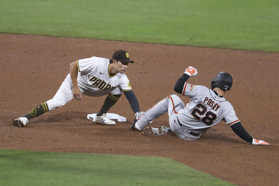 San Diego Padres shortstop Ha-Seong Kim tags out San Francisco Giants Buster Posey on a double play in the fifth inning of a baseball game Tuesday, April 6, 2021, in San Diego. (AP Photo/Derrick Tuskan)