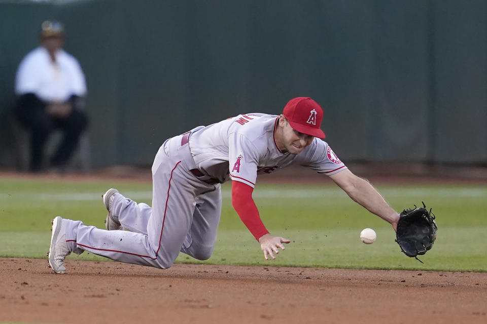 Los Angeles Angels third baseman Phil Gosselin reaches for a single hit by Oakland Athletics' Jonah Bride during the third inning of a baseball game in Oakland, Calif., Monday, Aug. 8, 2022. (AP Photo/Jeff Chiu)