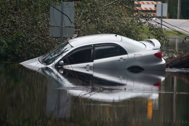 FILE PHOTO: Partially submerged car is pictured on flooded street after Hurricane Florence struck Piney Green