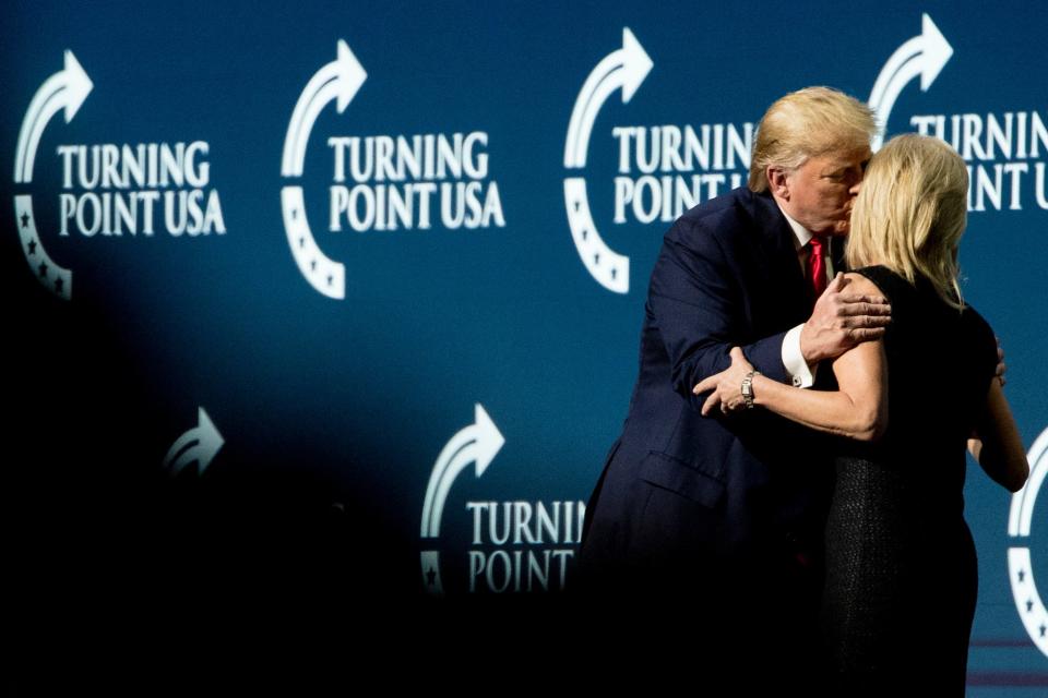 President Donald Trump kisses radio personality Laura Ingraham as he invites her up on stage during his speech at the Turning Point USA Student Action Summit at the Palm Beach County Convention Center in West Palm Beach, Fla., Saturday, Dec. 21, 2019.