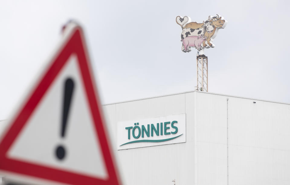 18 June 2020, North Rhine-Westphalia, Rheda-Wiedenbrück: View of a business logo of Tönnies on a production hall and behind a traffic sign ("Gefahrenstelle"). At the Tönnies slaughterhouse in Rheda-Wiedenbrück, hundreds of employees have been tested positive for the coronavirus since the beginning of the week. Photo: Friso Gentsch/dpa (Photo by Friso Gentsch/picture alliance via Getty Images)