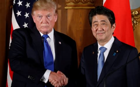  Donald Trump and Japan's Prime Minister Shinzo Abe shake hands at the end of a news conference at Akasaka Palace in Tokyo, Japan - Credit:  REUTERS