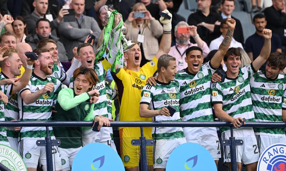 <span>Celtic’s Callum McGregor and Joe Hart lift the trophy after victory over Rangers.</span><span>Photograph: Stu Forster/Getty Images</span>