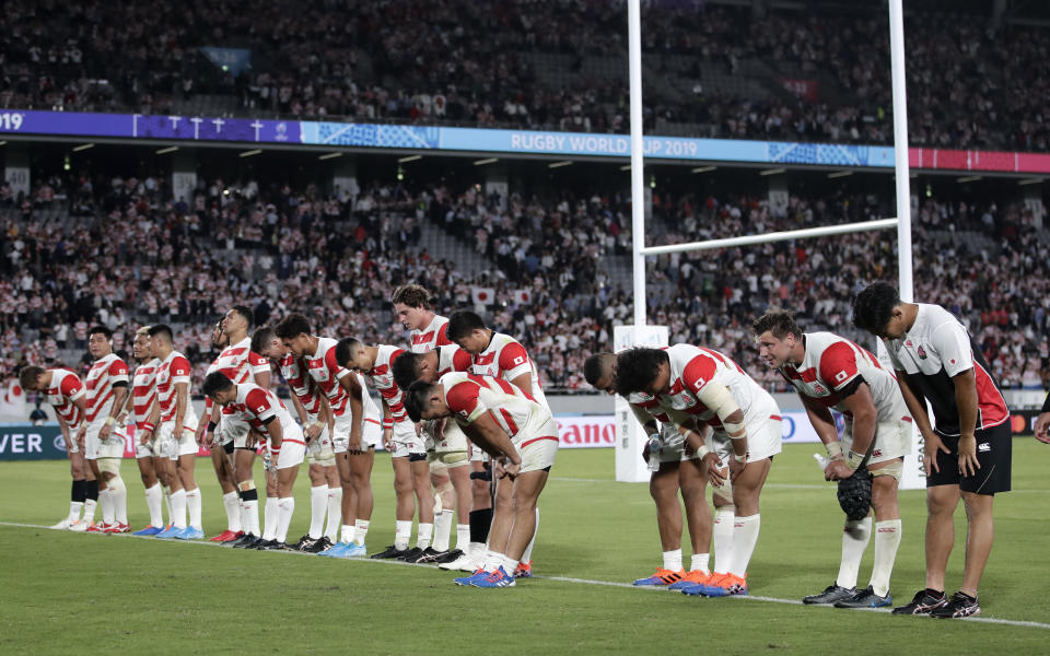 Japan players bow to the crowd as they celebrate following their 30-10 win over Russia during the Rugby World Cup Pool A game at Tokyo Stadium in Tokyo, Japan, Friday, Sept. 20, 2019. (AP Photo/Jae Hong)