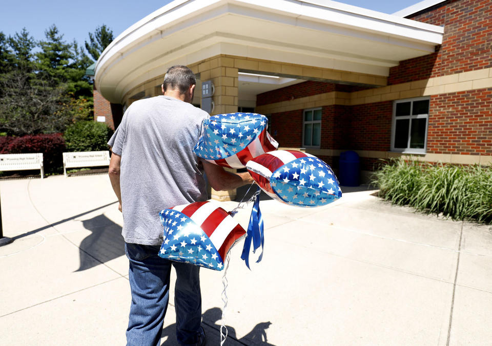 <p>A man brings balloons into Wyoming High School, site of tomorrow’s funeral for Otto Warmbier June 21, 2017 in Wyoming, Ohio. (Photo: Bill Pugliano/Getty Images) </p>