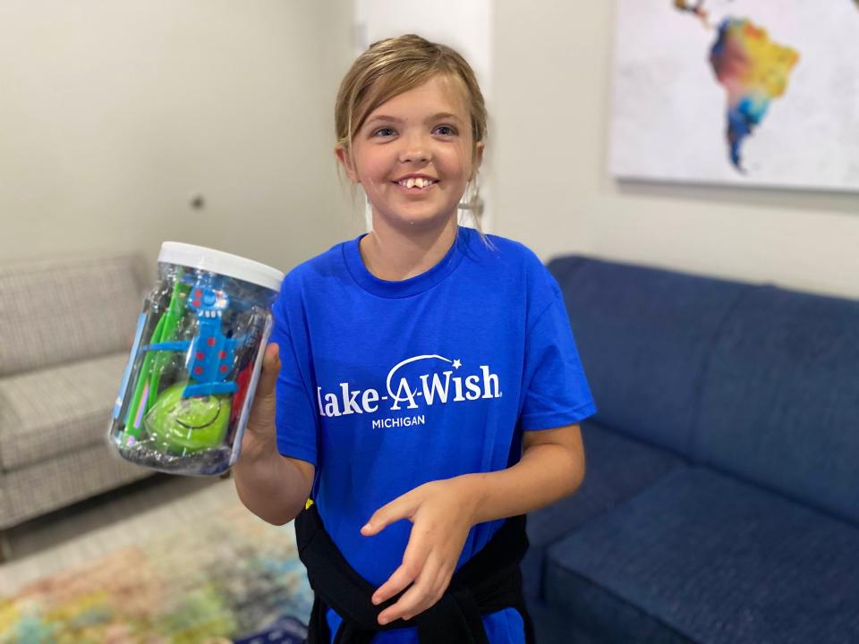 Charlie Buckley of Battle Creek opens one of the many gifts she received while at Give Kids the World Village in Kissimmee, Fla. as part of her wish through Make-A-Wish Michigan.