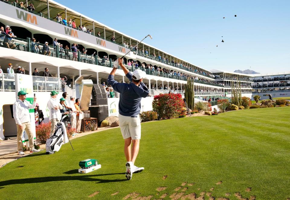 Feb 8, 2023; Scottsdale, AZ, USA; Defending champion Scottie Scheffler plays his tee shot on the 16th hole in the Annexus Pro-Am during the WM Phoenix Open at TPC Scottsdale. Mandatory Credit: Rob Schumacher-Arizona Republic