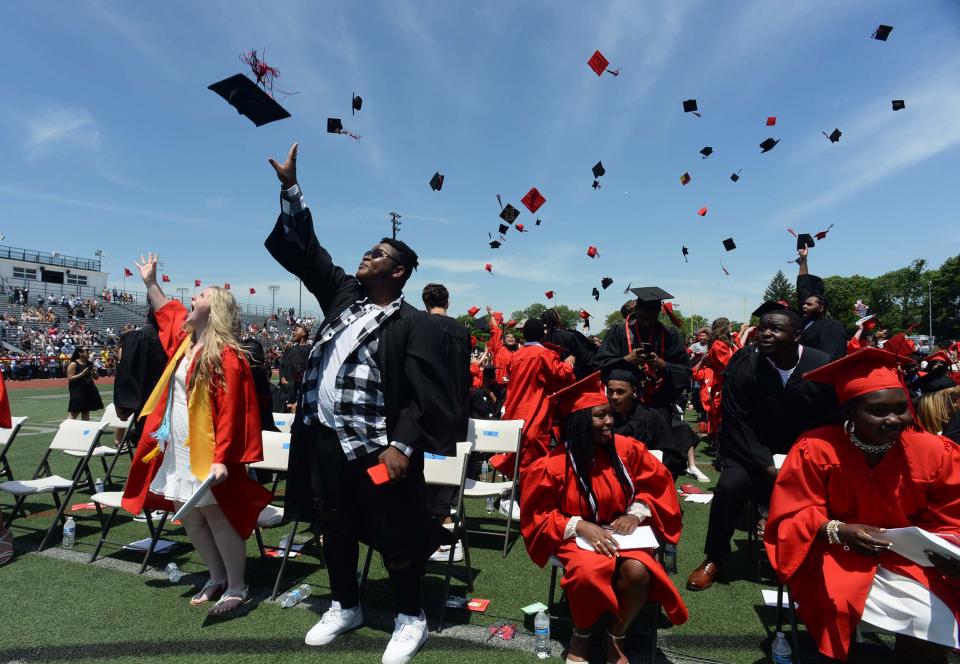 Graduates toss their caps at the conclusion of the 155th graduation exercises for Brockton High School, on Saturday, June 5, 2021, during the green/red buildings ceremony.