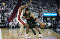 Boston Celtics forward Jayson Tatum, right, drives to the basket against Miami Heat forward Haywood Highsmith during the first half of Game 3 of an NBA basketball first-round playoff series, Saturday, April 27, 2024, in Miami. (AP Photo/Wilfredo Lee)