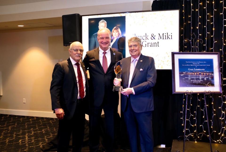 Joe Petrock, left, and Jeff Feasel, center, present Charles "Chuck" Grant with the Civic League of the Halifax Area's Beacon Award at the nonprofit organization's annual dinner at Oceanside Country Club in Ormond Beach on Saturday, Jan. 20, 2024.