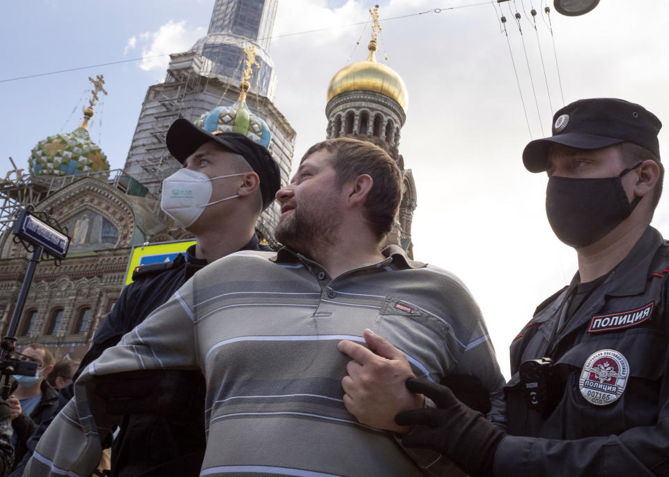 Police detain a protester during a rally supporting Khabarovsk region's governor Sergei Furgal in St.Petersburg, Russia, Saturday, Aug. 1, 2020. Thousands of demonstrators rallied Saturday in the Russian Far East city of Khabarovsk to protest the arrest of the regional governor, continuing a three-week wave of opposition that has challenged the Kremlin. (AP Photo/Dmitri Lovetsky)