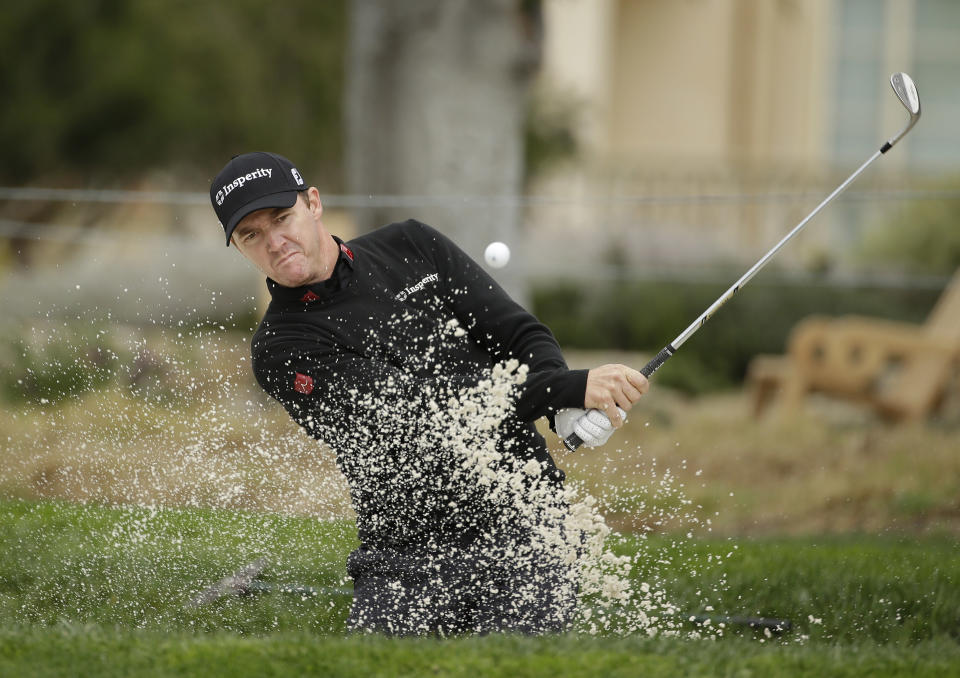Jimmy Walker hits out of a bunker onto the second green during the final round of the AT&T Pebble Beach Pro-Am golf tournament, Sunday, Feb. 9, 2014, in Pebble Beach, Calif. (AP Photo/Eric Risberg)