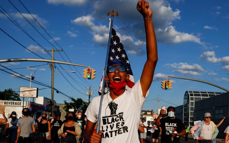 A Black Lives Matter protester in New York state on Tuesday - AP