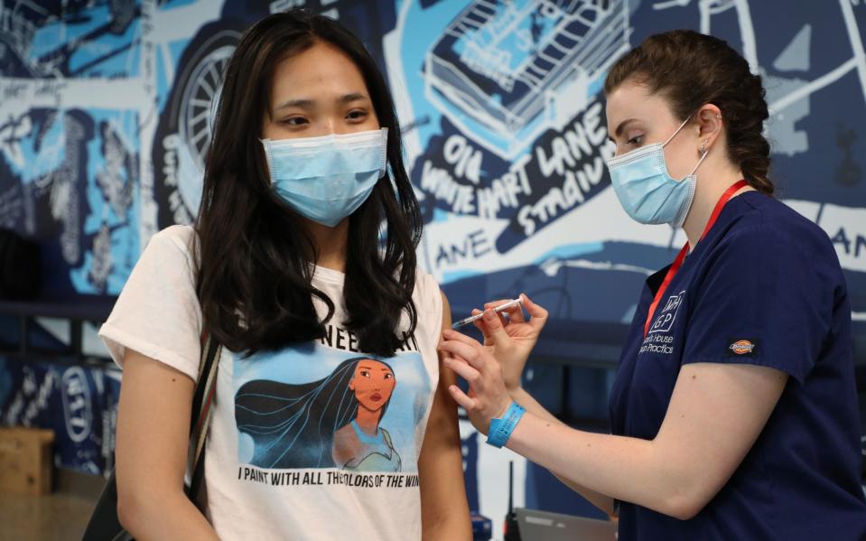 A woman receives a jab at a Covid-19 vaccination clinic in London. - Tottenham Hotspur FC 