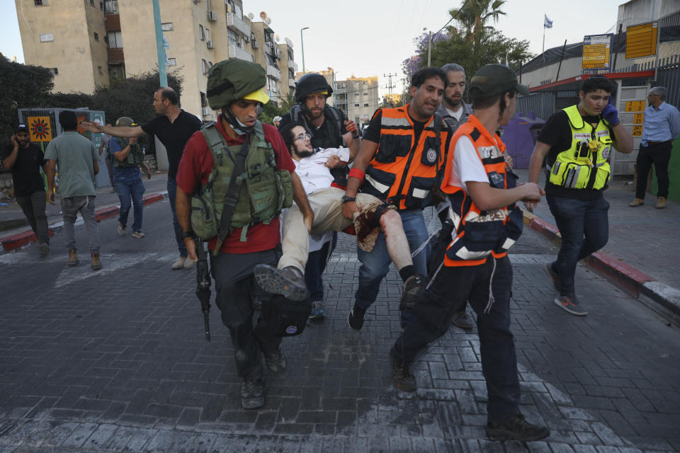 Israeli security forces and paramedics carry a wounded Jewish man after he was shot during violent unrest in Lod, Israel, Thursday, May 13, 2021. The man was shot, allegedly by an Arab man, during violent clashes between Jews and Arabs in the central city of Lod, Israeli media reported. (AP Photo/Ofer Vaknin)