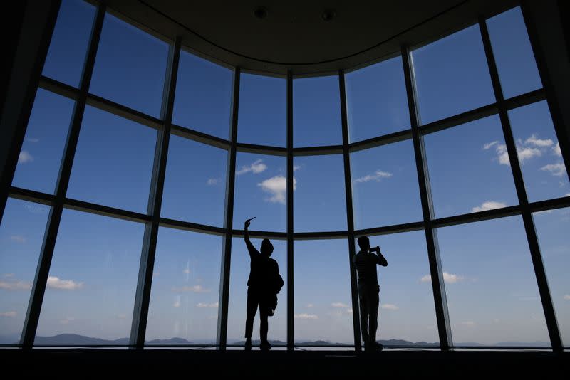 FILE PHOTO: Visitors wearing masks to avoid the spread of the coronavirus disease (COVID-19) take a selfie at the Seoul Sky Observatory in Seoul