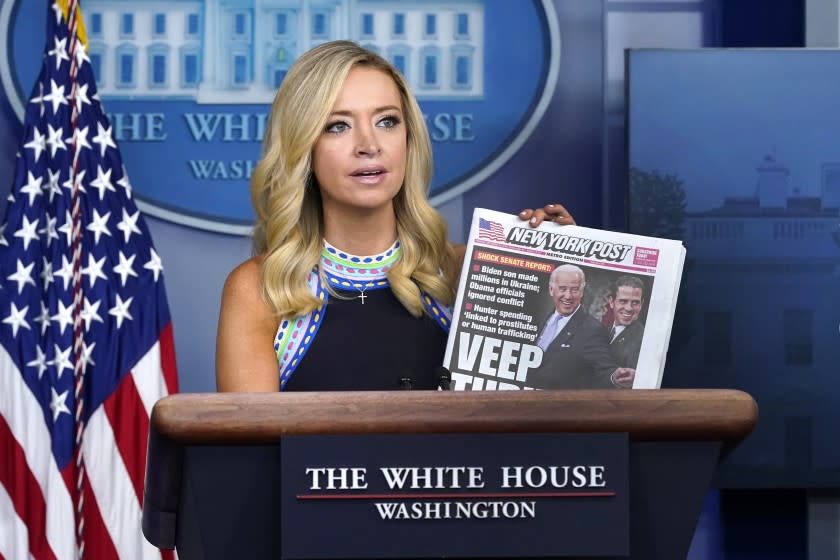 White House press secretary Kayleigh McEnany displays a copy of the New York Post as she speaks during a news conference at the White House, Thursday, Sept. 24, 2020, in Washington. (AP Photo/Patrick Semansky)