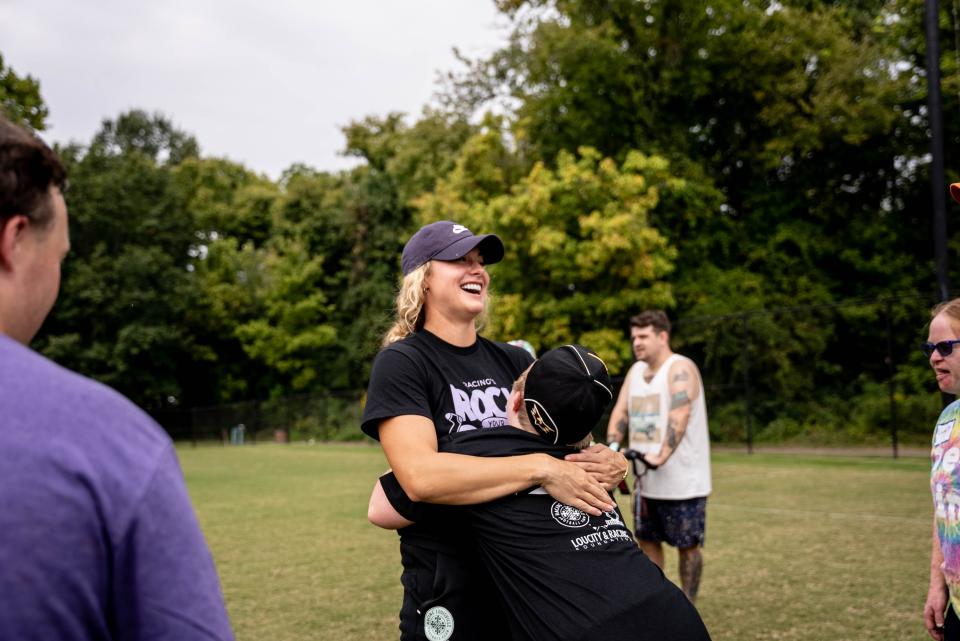 Racing Louisville FC midfielder Jaelin Howell embraces a member of Down Syndrome of Louisville during the Rock Your Socks soccer clinic Sept. 17.