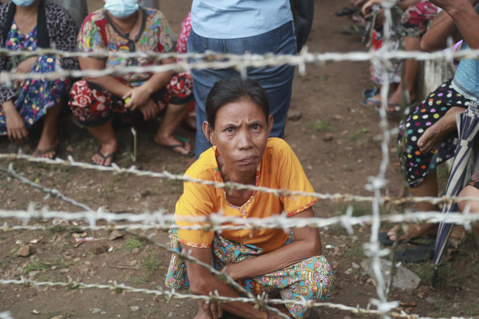 Family members and friends wait to welcome released prisoners outside the Insein Prison Tuesday, Oct. 19, 2021, in Yangon, Myanmar. Myanmar's government on Monday announced an amnesty for thousands of prisoners arrested for taking part in anti-government activities following February's seizure of power by the military. (AP Photo)