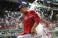 Boston Red Sox's Rafael Devers is doused with ice water to celebrate the team's 6-2 victory over the New York Yankees in a baseball game at Fenway Park, Friday, July 23, 2021, in Boston. Devers hit two home runs in the game. (AP Photo/Elise Amendola)