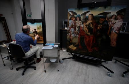 David Crombie, Senior Paintings Conservator at the National Museums, Liverpool carries out restoration work on the painting 'Am Not I A Man And A Brother', one of only 2 known paintings of its type in existence in Liverpool, Britain, July 30, 2019. Picture