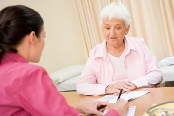 Woman in doctor's office frowning