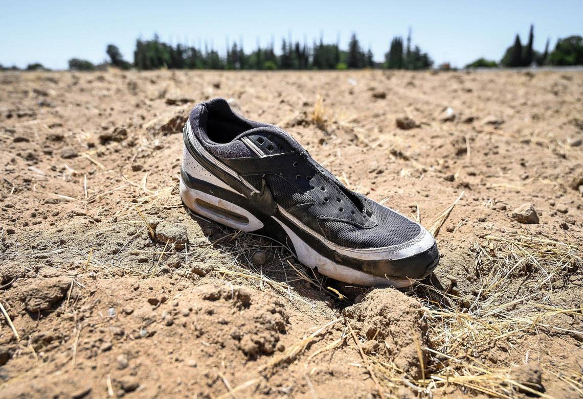 A shoe lies out in an empty field in west Fresno on Thursday, July 21, 0222 where a skull belonging to missing Luis A. Montana was found in October of 2021. Antonio Montana and his wife Graciela Alvarez Montana have been looking for answers to how their son was killed but have had trouble getting help.