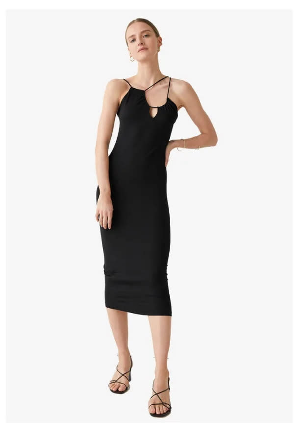 A model wears & Other Stories Asymmetric Sleeveless Midi Dress. (PHOTO: Zalora)