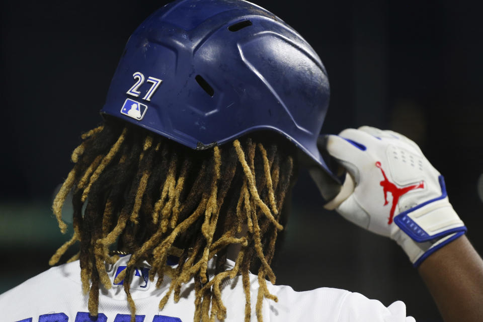 Toronto Blue Jays' Vladimir Guerrero Jr. puts on his batting helmet during the sixth inning of a baseball game against the Baltimore Orioles in Buffalo, N.Y., Thursday, June 24, 2021. (AP Photo/Joshua Bessex)