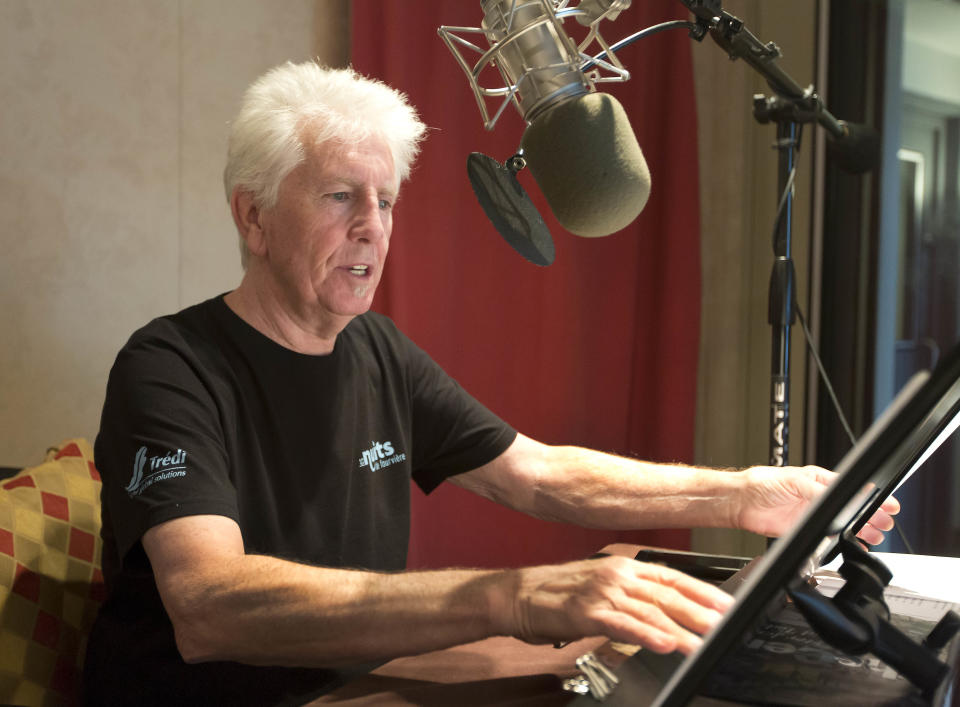 Singer Graham Nash prepares during the recording session for the audio book version of his "Wild Tales: A Rock & Roll Life" autobiography, in New York, Thursday, July 25, 2013. (AP Photo/Richard Drew)