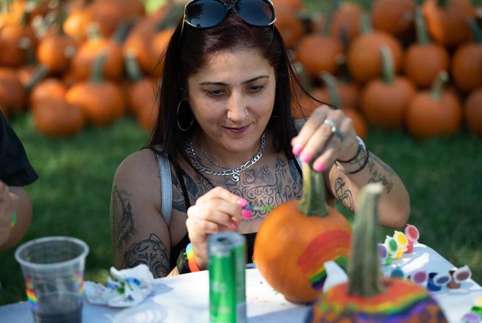 Sylvia Cuadras decorates a pumpkin during the MoPride festival at Graceada Park in Modesto, Calif., Saturday, Oct. 1, 2022. Andy Alfaro/aalfaro@modbee.com