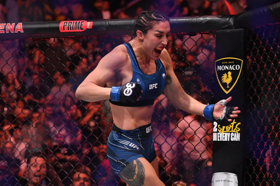 Aug 5, 2023; Nashville, Tennessee, USA; Tatiana Suarez (blue gloves) celebrates the win by submission over Jessica Andrade (red gloves) during UFC Fight Night at Bridgestone Arena. Mandatory Credit: Christopher Hanewinckel-USA TODAY Sports