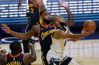 Minnesota Timberwolves guard Jordan McLaughlin, right, shoots against Golden State Warriors guard Brad Wanamaker during the first half of an NBA basketball game in San Francisco, Wednesday, Jan. 27, 2021. (AP Photo/Jeff Chiu)