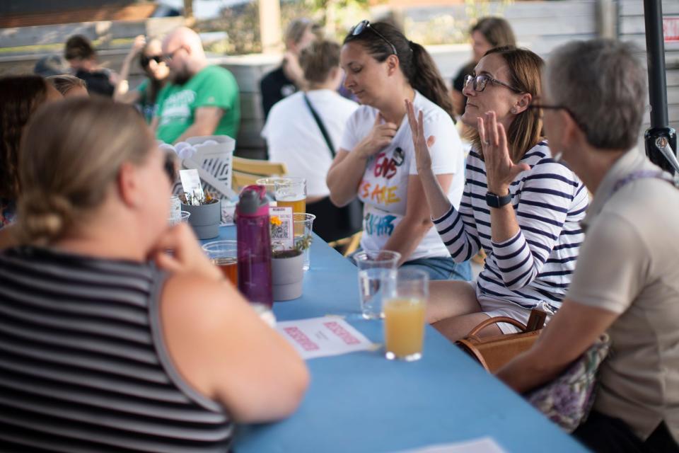 Alicia Shaw, center, of Worthington, talks with friends during a community care event held by abortion rights groups.