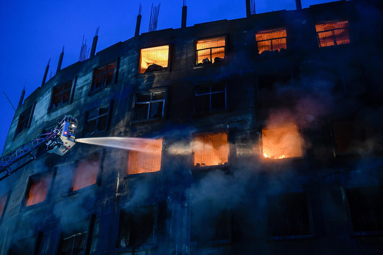 Firefighters try to extinguish a fire inside the building