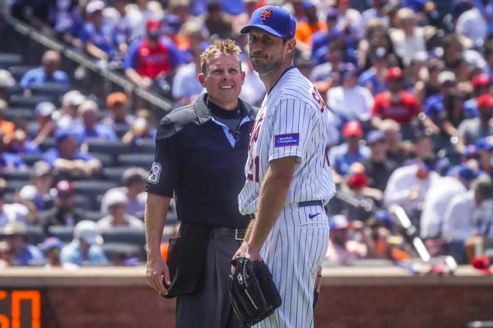 After a delay in his catcher taking the field in the fifth inning, Max Scherzer’s warm-up pitches were cut short Thursday. (AP/Bebeto Matthews)