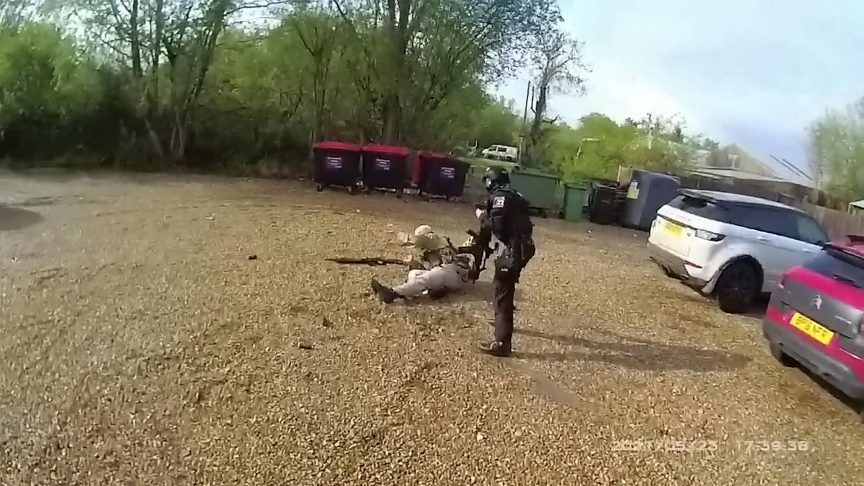 This is the dramatic moment a firearms police officer skillfully took down a suicidal paedophile armed with an imitation machine gun in Surlingham, Norfolk. See SWNS copy SWCAgun:  The quick-thinking cop shot Simon Tait, 38, in the leg with a rubber bullet after he pointed his fake M16 assault rifle straight at the officer.  Tait - who was found to have 1,000 child porn images in a separate offence - had earlier stormed into his local pub dressed in combat gear on Sunday, May 23. 