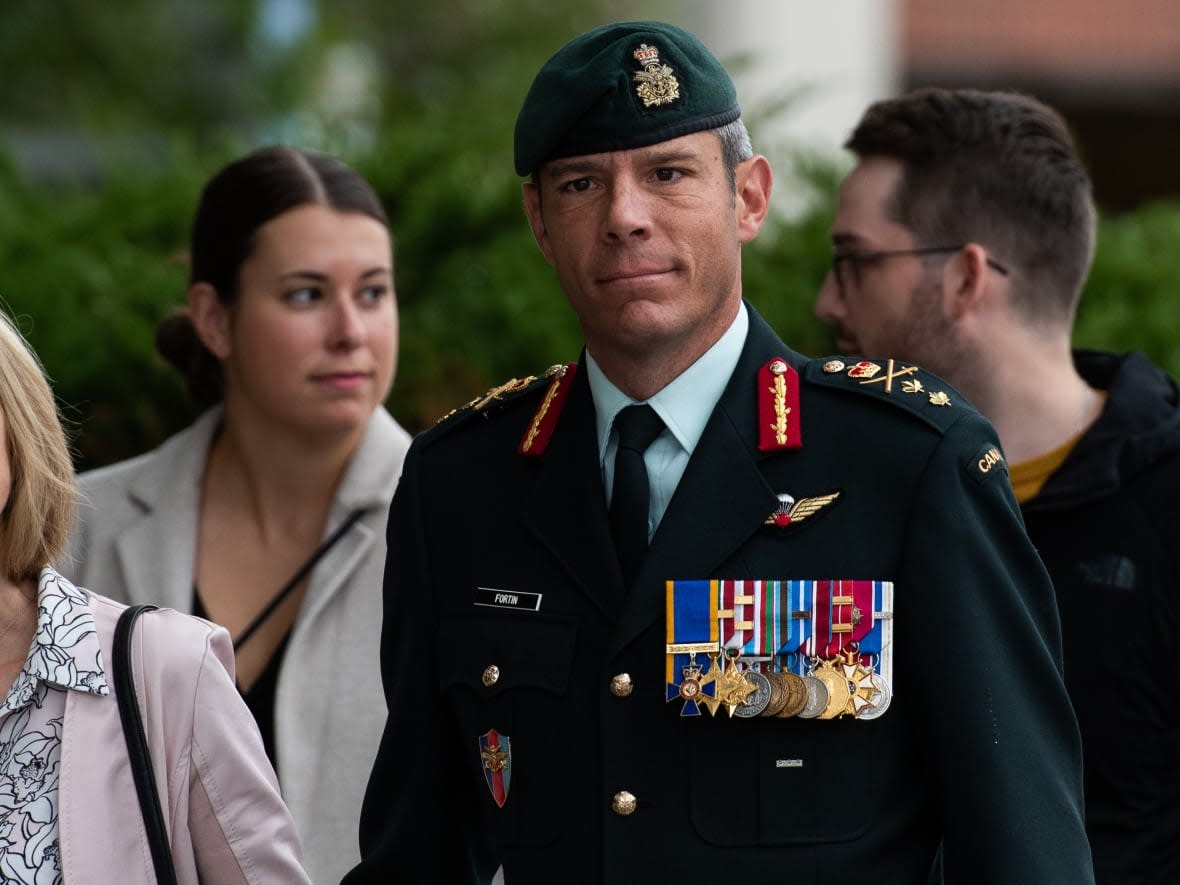 Maj.-Gen. Dany Fortin wears his uniform and medals as he arrives with his wife and daughter at the Gatineau, Que. courthouse for the second day of his trial. (Spencer Colby/The Canadian Press - image credit)