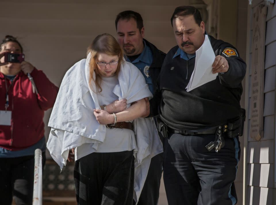 Sara Packer, handcuffed, was led out of District Court on Sunday. Source: AP