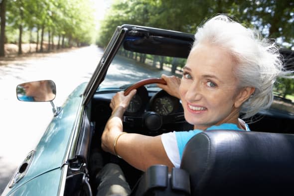 senior woman in sports car