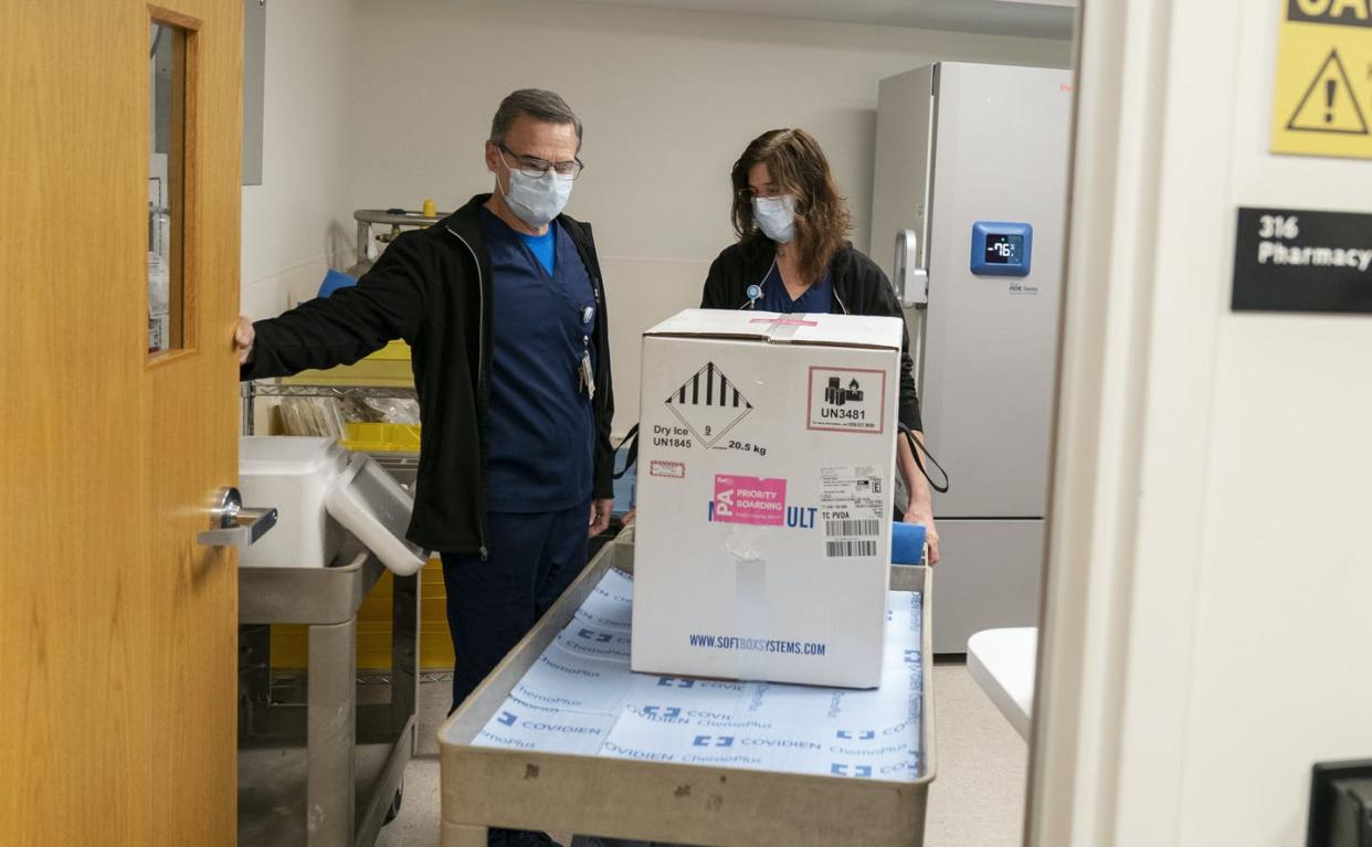 <span class="caption">The first COVID-19 vaccines arrive packed in dry ice and need special freezers that can keep them extremely cold.</span> <span class="attribution"><a class="link " href="https://newsroom.ap.org/detail/VirusOutbreakPfizerVaccineRhodeIsland/27922a209cf141e8b78a72ad19cc7b7f/photo" rel="nofollow noopener" target="_blank" data-ylk="slk:AP Photo/David Goldman;elm:context_link;itc:0;sec:content-canvas">AP Photo/David Goldman</a></span>