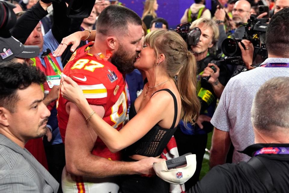 Travis Kelce shared a kiss with Taylor Swift after he and the Chiefs secured a victory during Super Bowl LVIII. AP