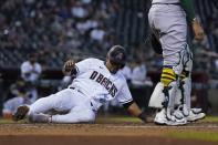 Arizona Diamondbacks' Eduardo Escobar scores a run against the Oakland Athletics during the third inning of a baseball game Tuesday, April 13, 2021, in Phoenix. (AP Photo/Ross D. Franklin)