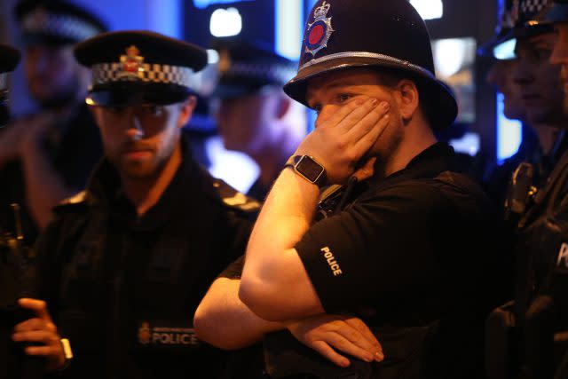 Police officers among mourners viewing tributes in St Ann's Square, Manchester