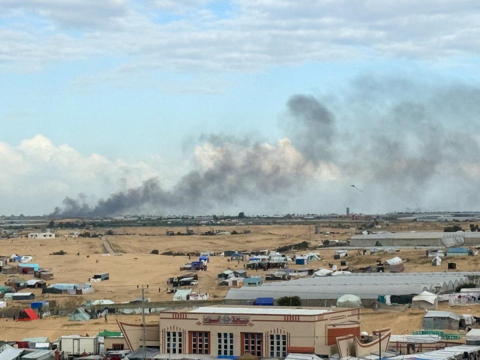 Smoke from the ground operation in Khan Younis, seen from a camp sheltering displaced Palestinians in Rafah (Reuters)