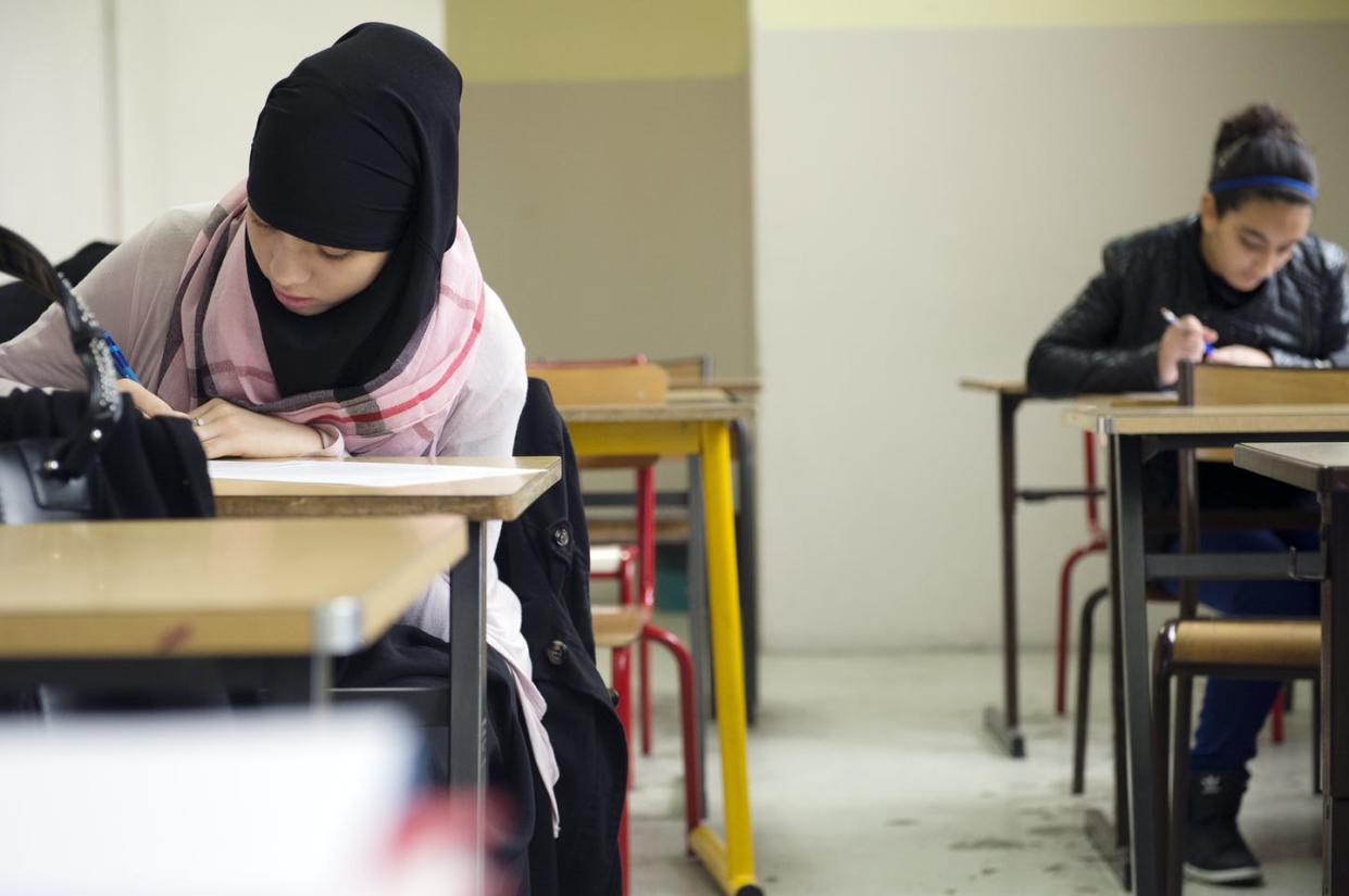 <span class="caption">Muslim schools can provide a place for girls to study while wearing headscarves.</span> <span class="attribution"><a class="link " href="https://www.gettyimages.com/detail/news-photo/muslim-faithful-students-are-pictured-in-their-classroom-at-news-photo/181284466?adppopup=true" rel="nofollow noopener" target="_blank" data-ylk="slk:Lionel Bonaventure/AFP via Getty Images;elm:context_link;itc:0;sec:content-canvas">Lionel Bonaventure/AFP via Getty Images</a></span>