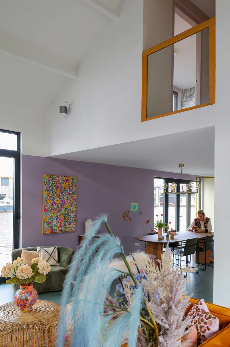 Indoor balcony and pastel dining area seen from living room.